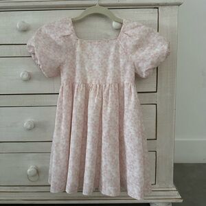 This dress is made by coconut. We bought it in Spain. It’s light pink with white